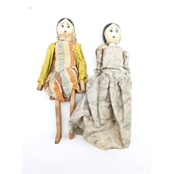 Two peg dolls with carved limbs and painted rounded faces H27cm