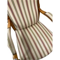 Beech framed armchair, with scrolled arms and upholstered in stripe fabric, raised on cabriole supports 