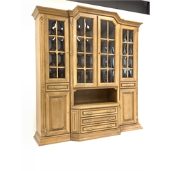 20th century oak breakfront display cabinet, the top section fitted with central glazed cupboard enclosing three fixed shelves, flanked by a further two cupboards each enclosing one shelf, and two drawers, three drawers and two cupboards under