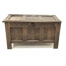 Late 17th/ Early 18th century oak coffer, the panelled top lifting to reveal plain interior over lunette carved frieze and three panels, raised on stile supports W110cm
