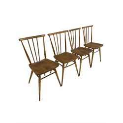 Set four Ercol blonde beech and elm chairs, the spindle back over elm seat, raised on turned supports 