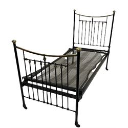 Early 20th century brass single bedstead, with brass vono cross rails and mesh base, raised on castors