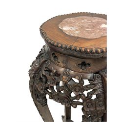 Late 19th to early 20th century century tall Chinese carved hardwood jardinière or urn stand, rose marble top in bead carved surround, pierced and carved flower head and foliage frieze rails, on dragon mask carved cabriole supports with trailing floral decoration, joined by carved and pierced under-tier 