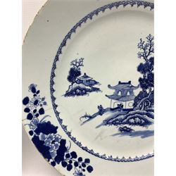 18th century Chinese Export porcelain blue and white charger, centrally decorated with pagoda beneath a rocky outcrop on the shore of a lake within a scroll border and floral sprays around the rim D42.5cm, together with three further 18th century Chinese blue and white plates, one painted with a similar pagoda scene, the second painted with chrysanthemum and floral sprigs and a the last with a pine tree within geometric borders (4) 