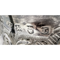 Late George II silver two handled cup engraved with a crest and with a later  embossed ploughing scene, flowers etc on a pedestal foot H12cm London 1758 Maker probably Benjamin Cartwright I 9.2oz
