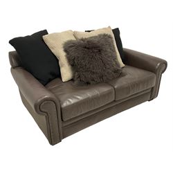 Tetrad - two seat sofa upholstered in brown leather with contrasting scatter cushions 