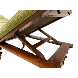 19th century mahogany and cane work campaign bed, with green squab cushion, adjustable seat, back and leg rest, on turned feed with brass cups and ceramic castors