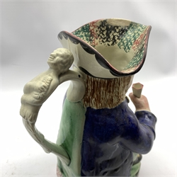 Pratt Type pottery toby jug of traditional form holding a cup and jug on a sponge base, H26cm