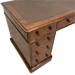 Victorian mahogany twin pedestal desk, moulded rectangular top with rounded corners and inset leather top, fitted with nine drawers, on skirted base