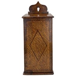 George III oak candle box, of tapering rectangular form, with pierced shaped cresting, hinged sloping cover, the front inlaid with a lozenge, H41.5cm 
