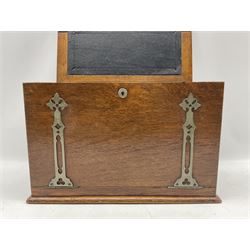 Victorian oak stationary box with strapwork hinged cover with applied monogram, folding black leather writing surface and fitted interior interior of stationary compartments, H28cm x W42.5cm 