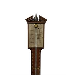 Mid-20th century mercury stick barometer and an early 20th century aneroid wheel barometer. Mahogany stick barometer with a broken pediment and brass finial, silvered register with engraved predictions and vernier, unenclosed bulb cistern tube with mercury present. Carved oak aneroid barometer with an 8” porcelain dial, predictions, and a boxed mercury thermometer above, steel indicating and recording hands within a brass bezel with a flat beveled glass.
