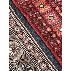 Hand knotted Bokhara red ground rug with gul motif and boarded (96cm x 164cm), together with a Turkish beige ground rug (120cm x 188cm)