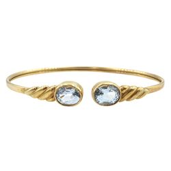 9ct gold two stone blue topaz torque bangle, stamped 375
