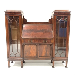  Early 20th century mahogany bureau bookcase, the fall front revealing tooled leather writing surface, drawers and cubby holes, over two cupboard doors, flanked by two bookcases with gadroon moulding and tracery glazed doors enclosing three shelves each, raised on square tapered supports, W154cm, H144cm, D40cm  