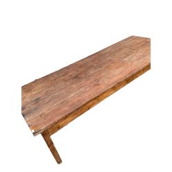 Large early 19th century pine kitchen table, rectangular plank top, on square supports joined by stretchers 