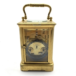  Early 20th century brass and bevelled glass carriage clock, white enamel dial with Arabic and Roman numerals, twin train driven movement striking the hours and half on coil, the back plate stamped '394', H15cm (not including handle upright)   