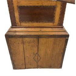 A late 19th century oak and mahogany longcase clock, with a swans neck pediment and break arch hood door, with ring turned pillars, oak trunk with canted corners, short oak door with mahogany inlay and a wavy top, on a rectangular pediment with cross banding and inlay, applied replacement painted dial with depictions of country scenes to the spandrels and break arch, Roman numerals, minute track and subsidiary seconds dial, dial inscribed “Kern, Swansea” with an eight day weight driven movement striking the hours on a bell. With pendulum.
