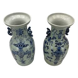 Pair of 18th/ 19th century Chinese twin-handled baluster vases, each painted in underglaze blue with precious objects against a pale celadon ground and pierced blue glaze handles, H42cm 