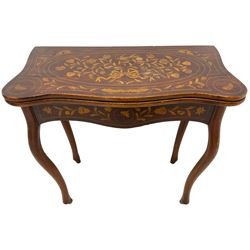 19th century Dutch marquetry inlaid card table, the shaped fold-over swivel top inlaid with ribbon bow and intertwined foliate, shaped front and side rails inlaid with flowers, on cabriole supports
