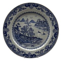 18th century Chinese export plate decorated in blue and white with buildings, river landscape etc within a floral and trellis border D31cm