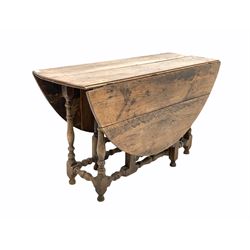 18th century oak drop leaf table, the oval top raised on turned and block supports with gate leg action, 125cm x 138m, H68cm