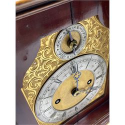A late 19th century Mahogany Bracket clock with a brass handle to the bell top pediment, foliate brass spandrels flanking the glazed full length ogee shaped door, with reeded canted corners and pierced wooden sound frets to the sides, on a brass fronted moulded plinth raised on corresponding bracket feet, with a deeply engraved gilt brass dial and five-inch silvered chapter ring with Roman numerals, minute track and five minute Arabic’s, matted dial center with pierced trefoil steel hands, subsidiary ring for strike/silent operation, eight day chain driven twin fusee movement striking the hours and half hours on a coiled gong, rack strike with a recoil anchor escapement, pendulum holdfast to the backplate, chapter ring inscribed “ A & H Rowley, London”.
With key.
Arthur and Henry Rowley were a firm of London clock retailers, at 67 Lion Street, Clerkenwell (1860-9) and afterwards at 180 Grey’s Inn Road, finally at 40 Theobalds Road , London (1881-1906).  
