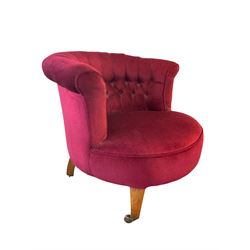 Late Victorian tub-shaped salon chair, buttoned back upholstered in red, square tapering supports with brass and ceramic castors