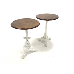 Pair of Victorian design cast iron tables, with circular mahogany tops raised on raised in column and intertwined fish leading to a leaf cast platform base and triple splay supports, D57cm