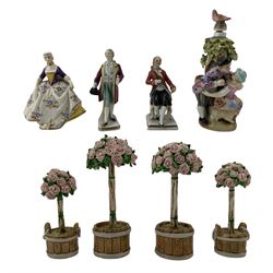 Two miniature Naples porcelain figures, Sitzendorf porcelain scent bottle modelled as a courting couple below a tree H11cm, miniature Sitendorf figure of a gentleman, together with four porcelain models of rose trees, signed S. Bartley, possibly Stephen Bartley (8) Provenance: From the Estate of the late Dowager Lady St Oswald
