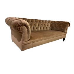 Early 20th century Chesterfield sofa, upholstered in velvet fabric with turned feet and brass castors