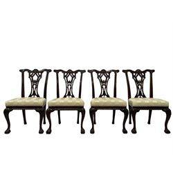 Set of eleven (9+2) Chippendale design mahogany dining chairs, the shaped cresting rail carved with central shell motif and scrolled foliage, pierced and foliate carved splat back, over-stuffed upholstered seats in striped pale fabric, gadroon carved seat rail, acanthus carved cabriole front supports with ball and claw feet, the carvers with extending arms with acanthus leaf carved terminals