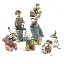 Three Lladro figures comprising The Balloon Seller, Gone Fishing and Playful Puppy and two Nao Clowns (5)