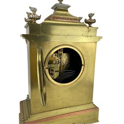 French - late 19th century 8-day brass cased mantle clock, with a tiered pediment surmounted by a central finial with mounted flambé finials to the corners, silvered two-part dial with Roman numerals, steel hands and a cast bezel flanked by two circular columns with Corinthian capitals, with contrasting applied filigree decoration to the pediment, pillars and front of the case, rectangular stepped plinth with a decorative base on block feet, Japy Freres twin train Parisian movement with square movement plates and rack striking, sounding the hours and half-hours on a coiled gong. With pendulum.