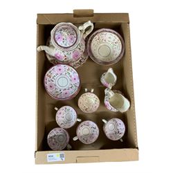 19th century pink lustre tea set comprising ten cups, twelve saucers, teapot, two jugs, two bowls and a plate