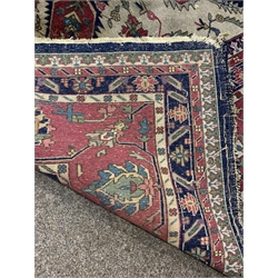 Large Persian design blue ground carpet, with lozenge medallion on blue field enclosed by stylised geometric decoration and multi line border, 550cm x 375cm