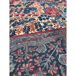 Persian hand knotted blue, ivory and red ground rug, with all over floral design 263cm x 380cm