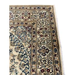 Silk inlaid Persian Kashan ivory ground rug, central floral design star medallion surrounded by trailing leafy branches and stylised plant motifs, guarded border with repeating pattern decorated with scrolls and floral motifs