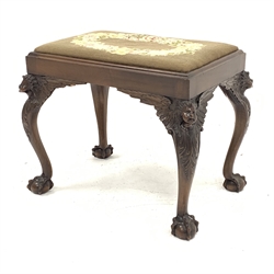 20th century mahogany dressing table stool, drop in seat upholstered in floral needlework cover, cabriole supports carved with winged cherubs, ball and claw feet, 61cm x 40cm (seat measurements), H53cm