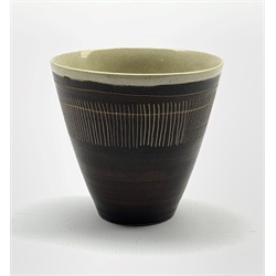 Dame Lucie Rie D.B.E (1902-1995) a stoneware beaker decorated to the exterior with sgraffito lines in a manganese glaze over off white, impressed seal mark, H7.5cm x D8cm