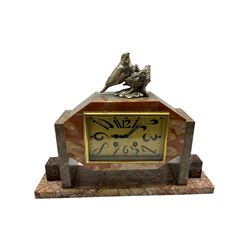 French Art Deco marble and granite cased mantle clock with a rectangular dial and elongated Arabic numerals, with an eight-day French striking movement, striking the hours on a bell. With pendulum and key.


