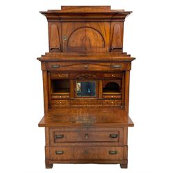 19th century mahogany architectural secretaire a abattant, the top section with projecting cornice over arched panelled door enclosed by applied shaped mounts, the lower section with frieze drawer over fall front, the interior fitted with a drawers and central cupboard, three long drawers below