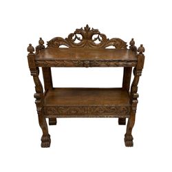 19th century carved oak buffet, raised pediment carved with scrolling foliage and two griffin heads, two tiers with foliate carved edges, the upper tier frieze carved with winged putto mask, scale carved dolphin uprights and serpentine supports carved with paw feet