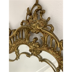 Rococo style cast gilt brass framed wall mirror, the frame decorated with undulating and conforming acanthus scrolls,