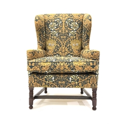 Early 19th century wing back armchair, upholstered in William Morris style liberty honeysuckle fabric, raised on ring turned mahogany supports 