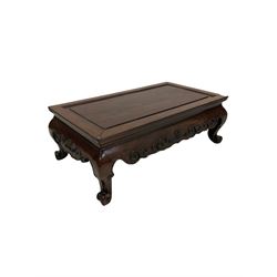 Chinese hardwood coffee table, the rectangular top and moulded edge over shaped apron, raised on scrolled supports 