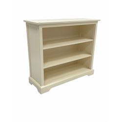 White painted three tier open bookcase with fixed shelves, W106cm, H93cm, D38cm