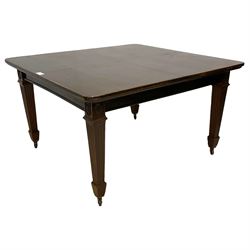 Early 20th century mahogany dining table, rectangular top with rounded corners, on flower head carved square tapering and fluted supports, brass and ceramic castors 