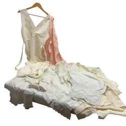 Quantity of early 20th century vintage undergarments to include white silk night gown with waist tie and embroidered detailing, another pink night gown together with cotton bloomers, camisoles, etc.