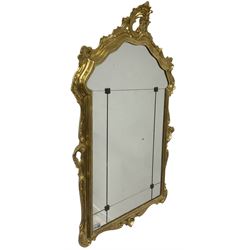 Wall mirror with a gilt frame, surmounted by a scrolled pediment  